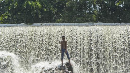 Karad: A boy reacts as he cools off in the Khodashi dam, during a hot summer day in Karad, (PTI)