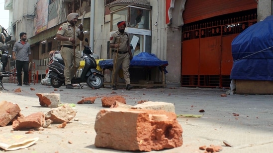 Police personnel patrol the street to maintain law and order after the clash that erupted between two groups near Kali Devi Temple in Patiala on Friday. (ANI Photo)(Harmeet Sodhi)