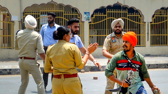 Security personnel attempt to maintain law and order after a clash broke out between followers of Shiv Sena and pro-Khalistani Sikh organisations, near Kali Mata Mandir in Patiala.(PTI)