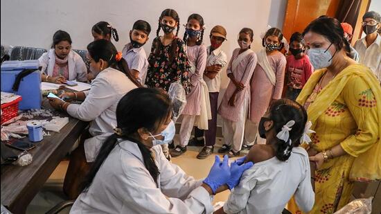 A healthcare worker administers a dose of Covid-19 vaccine to a student in the age group of 12-14 years, at a government school, in Jammu. (PTI)