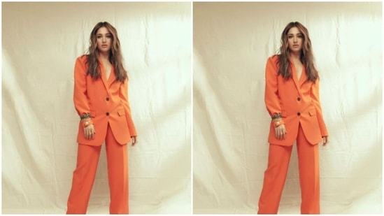 Tamannaah earlier turned muse for the fashion designer house Aak:Ch and aced the boss lady look in this vibrant orange a pant suit from their wardrobe.(Instagram/@tamannaahspeaks)