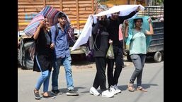 Youngsters cover their heads as they move in Prayagraj on an extremely hot day on Saturday. The city recorded a maximum temperature of 46.1 degrees Celsius, the third-highest ever to be registered in April, and 6 degrees above normal during the day as per the Indian Meteorological department. (Anil Kumar Maurya/HT Photo)