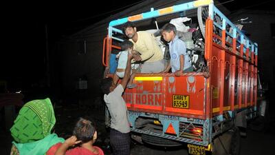 Residents leaving in a truck ahead of the demolition drive at Colony Number 4, Chandigarh, on Saturday night. (Ravi Kumar/HT)