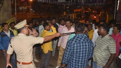 A policeman tries to disperse people after the imposition of Section 144 following violent clashes in the area over an objectionable social media post, in Hubballi. (PTI) A policeman tries to disperse people after the imposition of Section 144 following violent clashes in the area over an objectionable social media post, in Hubballi. (PTI)