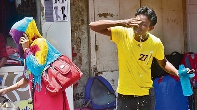 A youth washes his face for little respite in the sweltering heat as mercury rises in Mumbai. (HT_PRINT)
