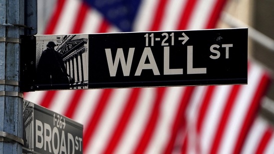 FILE PHOTO: A Wall Street sign is pictured outside the New York Stock Exchange amid the coronavirus disease (COVID-19) pandemic in the Manhattan borough of New York City, New York, U.S.(REUTERS)
