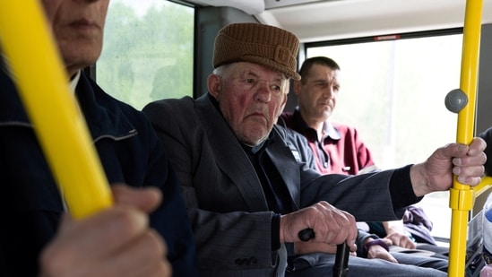 A Ukrainian man sits on a bus while being evacuated from the frontline city of Lyman, amid Russia's invasion of Ukraine, in Slovyansk, Donetsk region.(REUTERS)