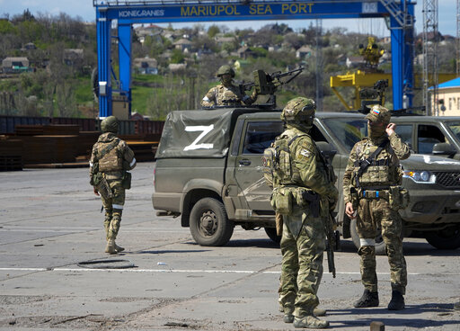 Russian servicemen gather as they guard an area of the Mariupol Sea Port in Mariupol, on April 29, 2022.&nbsp;(AP)