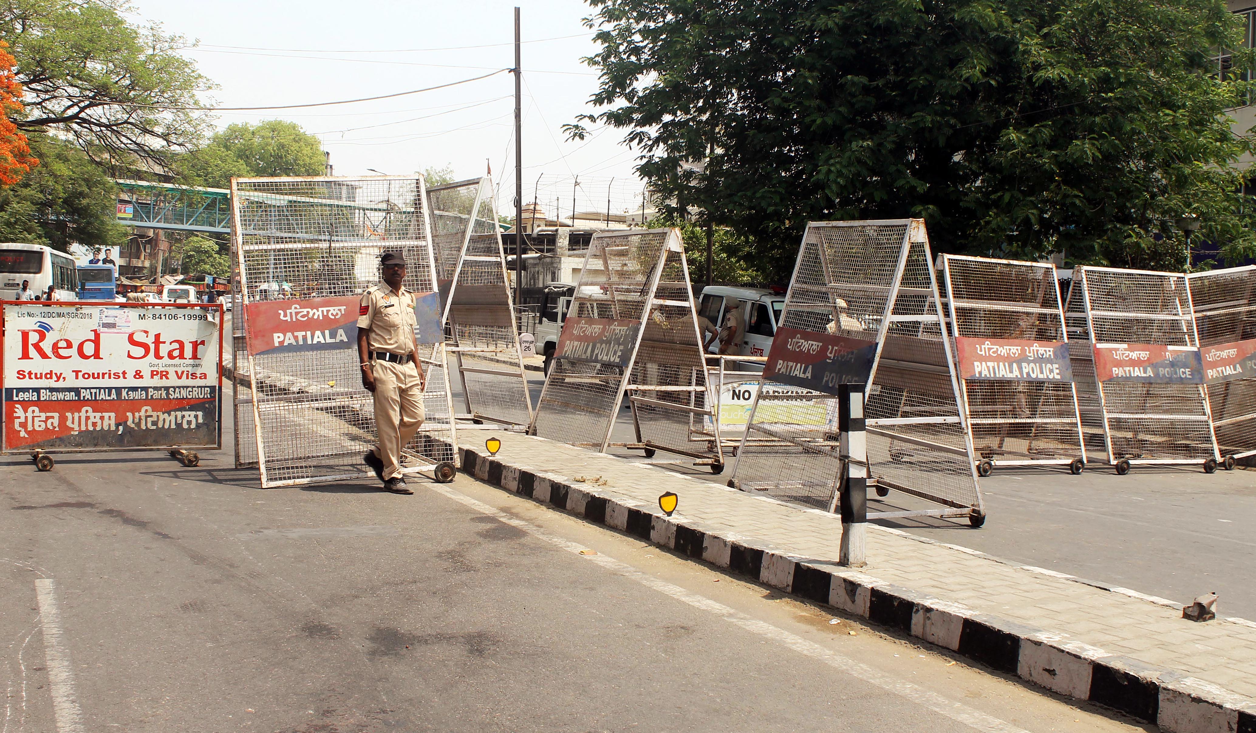 Police personnel stand guard near Kali Devi Temple to maintain law and order following the clash that took place between two groups, in Patiala, Punjab, on Saturday, April 30, 2022. (ANI Photo)( Harmeet Sodhi)