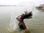 A girl takes a dip in the Ganga river to beat the heat on a hot summer day, in Prayagraj on Saturday.(ANI) A girl takes a dip in the Ganga river to beat the heat on a hot summer day, in Prayagraj on Saturday.(ANI)