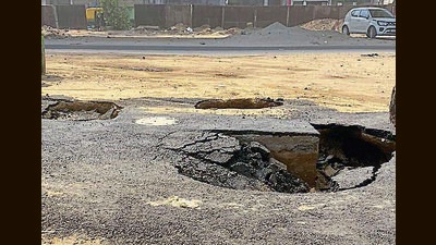 A pedestrian spotted craters forming on a newly laid service lane, and raised the alarm. Municipal corporation (MC) and National Highway Authority of India (NHAI) officials arrived at the spot, and a barricade was installed to divert traffic. (HT PHOTO ) A pedestrian spotted craters forming on a newly laid service lane, and raised the alarm. Municipal corporation (MC) and National Highway Authority of India (NHAI) officials arrived at the spot, and a barricade was installed to divert traffic. (HT PHOTO )