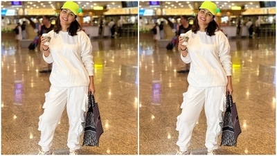 Hina teamed the all-white airport look with a neon green baseball cap and chunky white lace-up sneakers with black, silver and orange accents. She also carried a Christian Dior Book Tote Bag With Oblique Embroidery. It is worth <span class='webrupee'>₹</span>2,70,842 (13,000 UAE Dirhams). (Instagram/@realhinakhan) Hina teamed the all-white airport look with a neon green baseball cap and chunky white lace-up sneakers with black, silver and orange accents. She also carried a Christian Dior Book Tote Bag With Oblique Embroidery. It is worth <span class='webrupee'>₹</span>2,70,842 (13,000 UAE Dirhams). (Instagram/@realhinakhan)