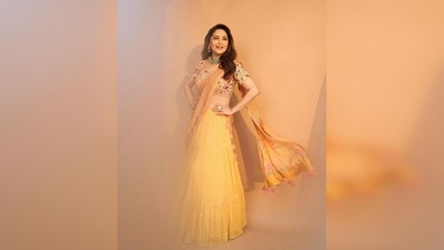 This gorgeous traditional peach and yellow embroidered lehenga set are from label Anushree's SS'22 collection. Madhuri Dixit's look was put together by celebrity stylist Ami Patel. (Instagram/@madhuridixitnene)