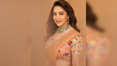 Madhuri Dixit accessorised her look with statement jewellery that comprised of bangles, studded earrings, jhumkas and a necklace. (Instagram/@madhuridixitnene)