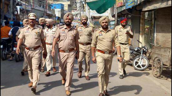 Police personnel patrol the street following the arrest of Barjinder Singh Parwana, the main accused of the clash that took place between two groups near Kali Devi Temple on April 29, in Patiala on Sunday. (ANI)