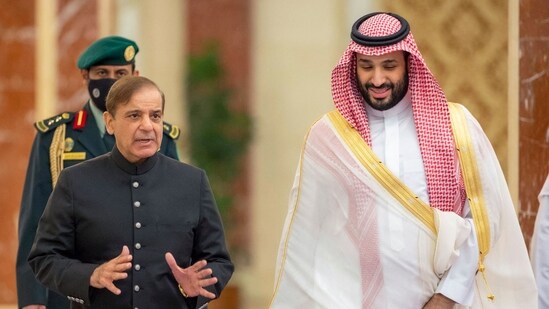 A handout picture provided by the Saudi Royal Palace shows Saudi Arabia's Crown Prince Mohammed Bin Salman (R) welcoming Pakistani Prime Minister Shehbaz Sharif in Jeddah.(AFP)
