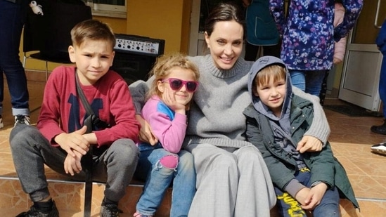 Actor and UNHCR Special Envoy Angelina Jolie poses for a picture with children, as Russia's attack on Ukraine continues, in Lviv, on April 30, 2022.&nbsp;(via Reuters)
