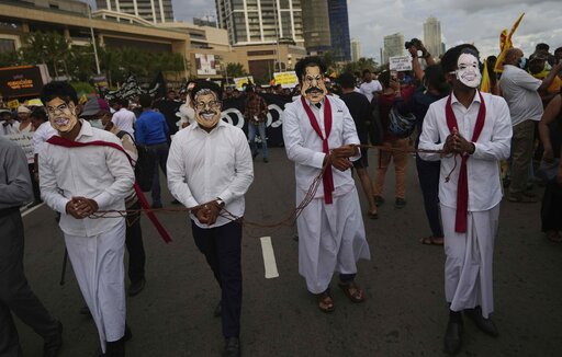 Sri Lankan protesters wear masks of president Gotabaya Rajapaksa's family members during a march demanding Gotabaya resign, at the ongoing protest site outside president's office in Colombo, on April 29, 2022. (AP) Sri Lankan protesters wear masks of president Gotabaya Rajapaksa's family members during a march demanding Gotabaya resign, at the ongoing protest site outside president's office in Colombo, on April 29, 2022. (AP)
