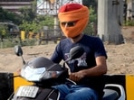 A man uses a piece of fabric while riding a two-wheeler, to shield his face during a heatwave, in Amritsar.(PTI) A man uses a piece of fabric while riding a two-wheeler, to shield his face during a heatwave, in Amritsar.(PTI)