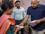Delhi Dy CM Manish Sisodia gives away a cheque worth rupees 1 crore to the family of LNJP nursing officer Raj Kumar who died while serving people during COVID-19 pandemic, in New Delhi, Monday, May 2, 2022. (PTI Photo)&nbsp;
