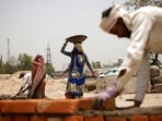 Labourers work at a construction site on a hot summer day in New Delhi, India, May 2, 2022. REUTERS/Adnan Abidi