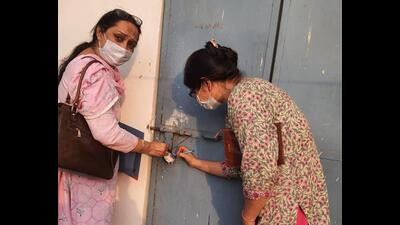 A health team sealing the couple’s centre at Rajiv Colony, Sector 17, Panchkula, on Monday. (HT Photo)