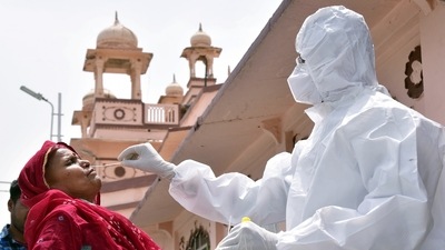 A healthcare worker collects a nasal swab sample of a passenger for the Covid-19 test, amid a surge in the Coronavirus cases. (HT Photo) A healthcare worker collects a nasal swab sample of a passenger for the Covid-19 test, amid a surge in the Coronavirus cases. (HT Photo)