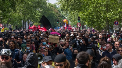Thousands of people joined May Day marches across France, calling for salary increases and for Macron to drop his plan to raise the retirement age. (Bloomberg) Thousands of people joined May Day marches across France, calling for salary increases and for Macron to drop his plan to raise the retirement age. (Bloomberg)