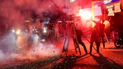 People light flare and firecrackers as they celebrate the eve of Eid al-Fitr in a street in Jakarta, Indonesia on Sunday. (AP) People light flare and firecrackers as they celebrate the eve of Eid al-Fitr in a street in Jakarta, Indonesia on Sunday. (AP)