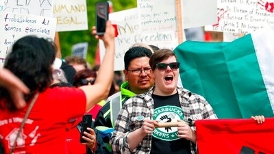 A Starbucks Workers Union member yells as the May Day march makes it way to Westlake Park in Seattle. (AP) A Starbucks Workers Union member yells as the May Day march makes it way to Westlake Park in Seattle. (AP)