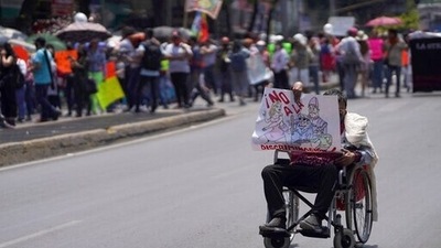 A man in a wheelchair holds a sign that reads in Spanish "No to discrimination," during a sex workers march to commemorate International Labour Day in downtown Mexico City. (AP) A man in a wheelchair holds a sign that reads in Spanish "No to discrimination," during a sex workers march to commemorate International Labour Day in downtown Mexico City. (AP)