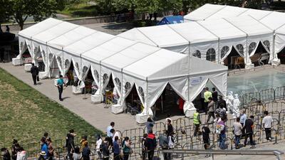 People line up outside a makeshift nucleic acid testing site during a mass testing for the coronavirus disease (COVID-19) in Haidian district of Beijing, China. (REUTERS)