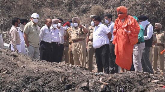 An NGT team visiting the Ludhiana landfill after a fire in April. The PPCB has imposed the fine citing the failure of urban local bodies in Punjab to comply with NGT orders. (HT File Photo)