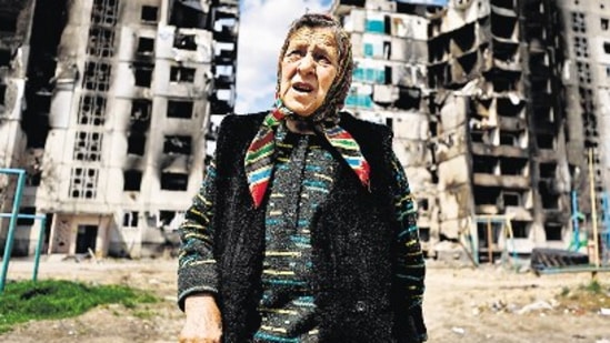 A woman reacts as she stands in front of a building, destroyed by the shelling, amid the Russian invasion of Ukraine, in Borodianka, Kyiv region, on Monday. (REUTERS)