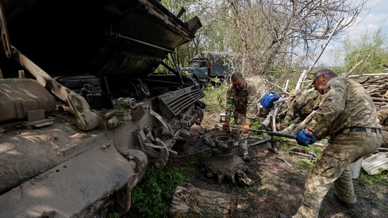 HT Ukrainian servicemen repair a tank at a position, as Russia's attack on Ukraine continues, in Kharkiv region, Ukraine.(REUTERS)