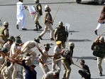 Police baton charge protesters after clashes broke out between two communities, in Jodhpur on Tuesday. (ANI)