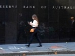A woman walks past the outside of the Reserve Bank in Sydney, Australia, A woman walks past the outside of the Reserve Bank in Sydney, Australia, 