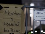 A sign hangs on a fence outside the US Supreme Court as protesters react to the leak of a draft majority opinion written by Justice Samuel Alito preparing for a majority of the court to overturn the landmark Roe v. Wade abortion rights decision. (REUTERS)