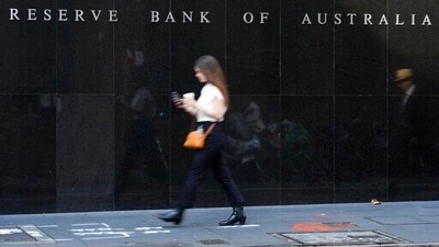 A woman walks past the outside of the Reserve Bank in Sydney, Australia,&nbsp; (AP)