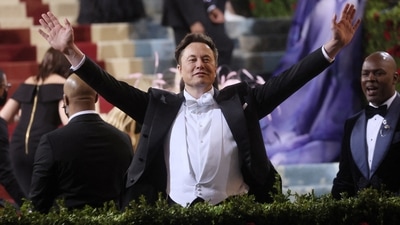 Tesla CEO Elon Musk, who has been the talk of the town ever since he bought Twitter for USD 44 billion, surprised everyone by making an appearance at Met Gala 2022 in a classic black tuxedo with coattails and a matching bow tie. (REUTERS)