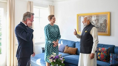 Prime Minister Narendra Modi interacts with Prime Minister of Denmark Mette Frederiksen as she shows him the painting he gifted her during her last visit to India, at her residence in Copenhagen. (PTI) Prime Minister Narendra Modi interacts with Prime Minister of Denmark Mette Frederiksen as she shows him the painting he gifted her during her last visit to India, at her residence in Copenhagen. (PTI)