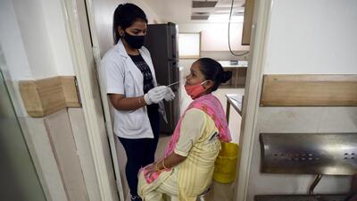 A health worker collects swab sample for a Covid-19 test in Noida on Tuesday. (Sunil Ghosh/ HT) A health worker collects swab sample for a Covid-19 test in Noida on Tuesday. (Sunil Ghosh/ HT)