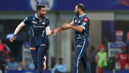 Mohammad Shami of Gujarat Titans celebrates with his captain Hardik Pandya after taking the wicket of Jonny Bairstow of Punjab Kings(PTI)