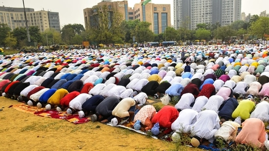 Muslims offer prayers on the occasion of Eid-ul-Fitr in Gurugram Sector 29 as National Flag unfurls in the back drop.(HT Photo/Raj K Raj)