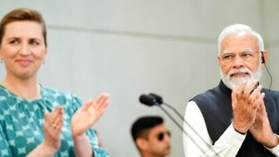 Prime Minister Narendra Modi (right) and his Danish counterpart Mette Frederiksen applaud during their joint press conference at the prime minister's official residence Marienborg, in Kongens Lyngby, north of Copenhagen, Denmark, Tuesday, May 3, 2022. (Martin Sylvest/Ritzau Scanpix via AP)