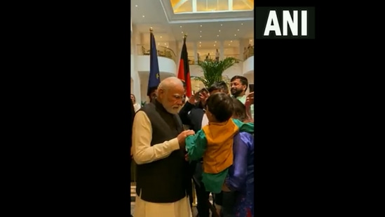 Prime Minister Narendra Modi interacts with an India boy in Germany on Tuesday, May 2, 2022. (ANI Photo)