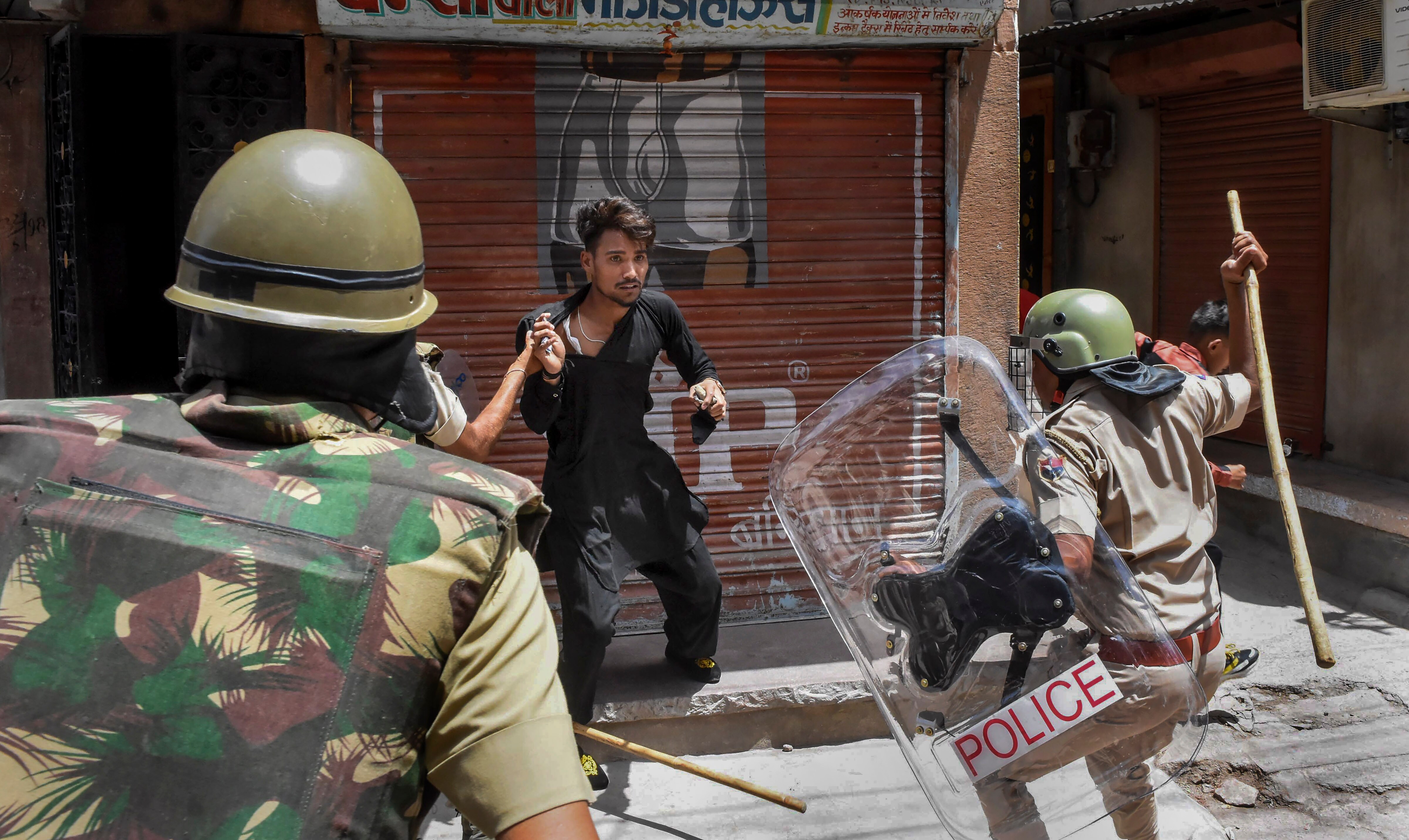 Police charge a miscreant to maintain peace after clashes broke out between two communities on Eid-ul-Fitr, in Jalori Gate area, in Jodhpur, Tuesday, May 3, 2022. (PTI Photo)