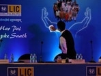 A man cleans a hoarding of Life Insurance Corporation of India (LIC) before the start of a news conference about the LIC initial public offering (IPO) launch, in Kolkata, (REUTERS File Photo) A man cleans a hoarding of Life Insurance Corporation of India (LIC) before the start of a news conference about the LIC initial public offering (IPO) launch, in Kolkata, (REUTERS File Photo)