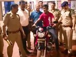 The image, taken from the Twitter video, show the policemen with the delivery boy to whom they gifted a bike.(Twitter/@mohdept)