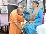 Uttar Pradesh Chief Minister Yogi Adityanath seeks blessings from his mother Savitra Devi, during their meeting, at his ancestral Panchur village in Pauri Garhwal.(PTI via Twitter) Uttar Pradesh Chief Minister Yogi Adityanath seeks blessings from his mother Savitra Devi, during their meeting, at his ancestral Panchur village in Pauri Garhwal.(PTI via Twitter)